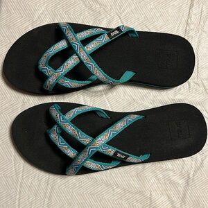 Black Teva sandals with blue/green straps